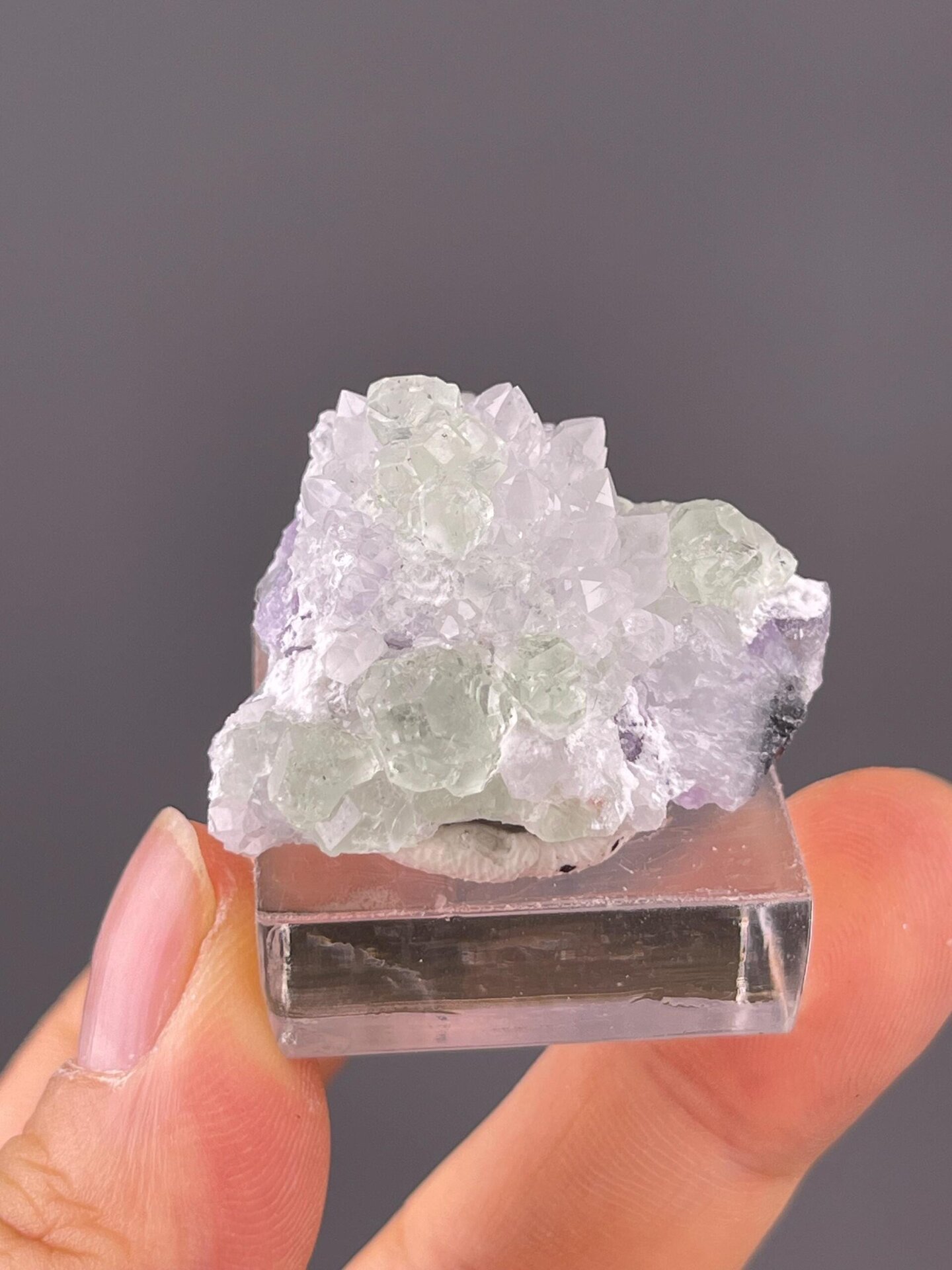 Quartz crystal clusters surrounding green fluorite