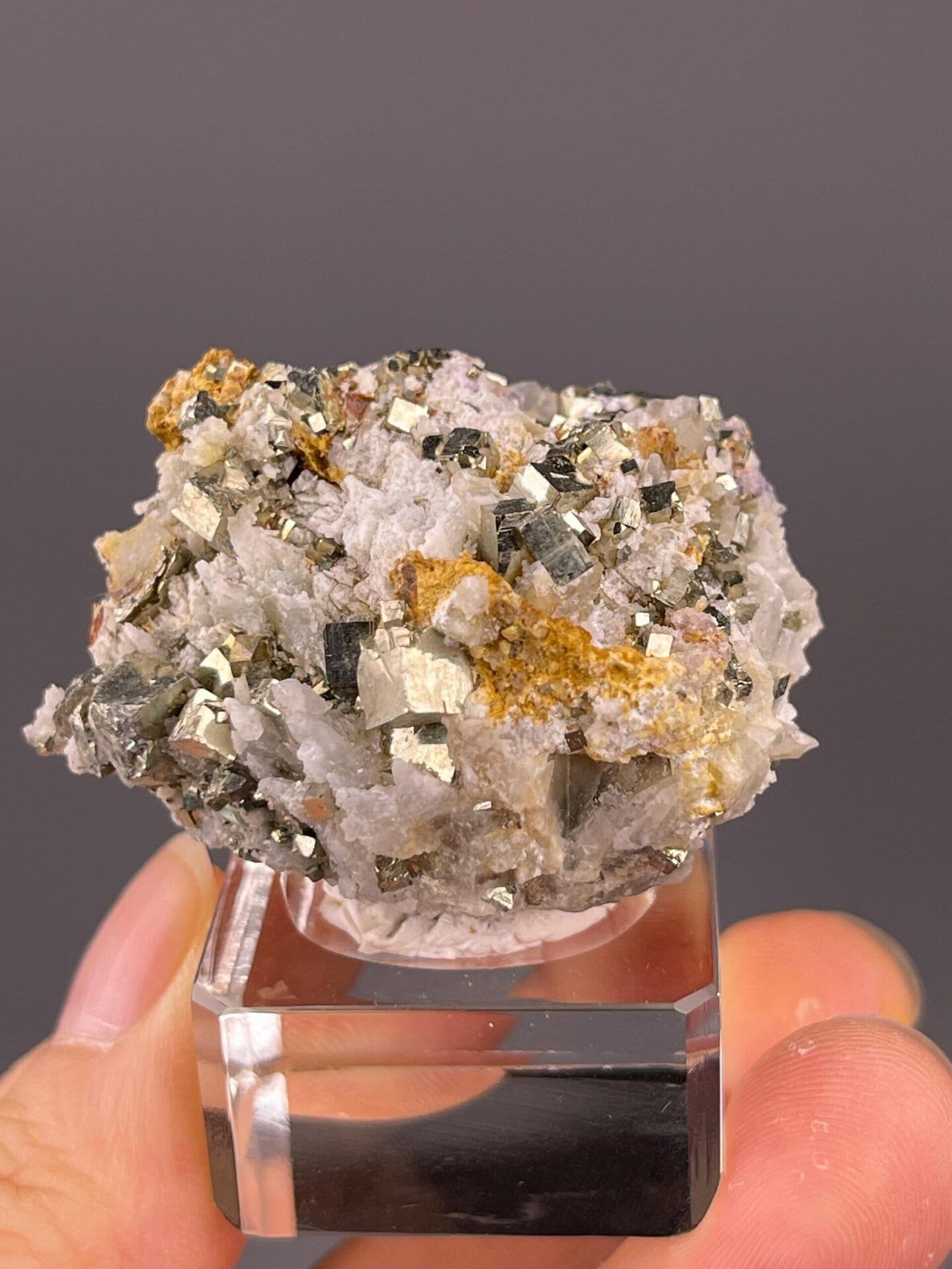 Golden metallic pyrite cubes on rock matrix
