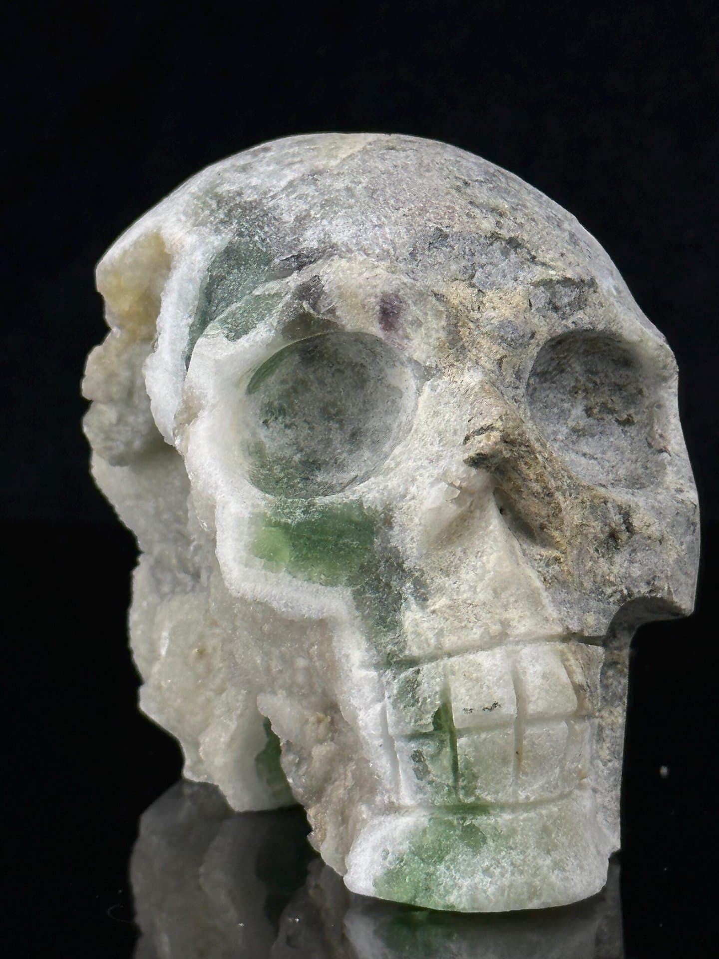Close-up of polished green fluorite skull face