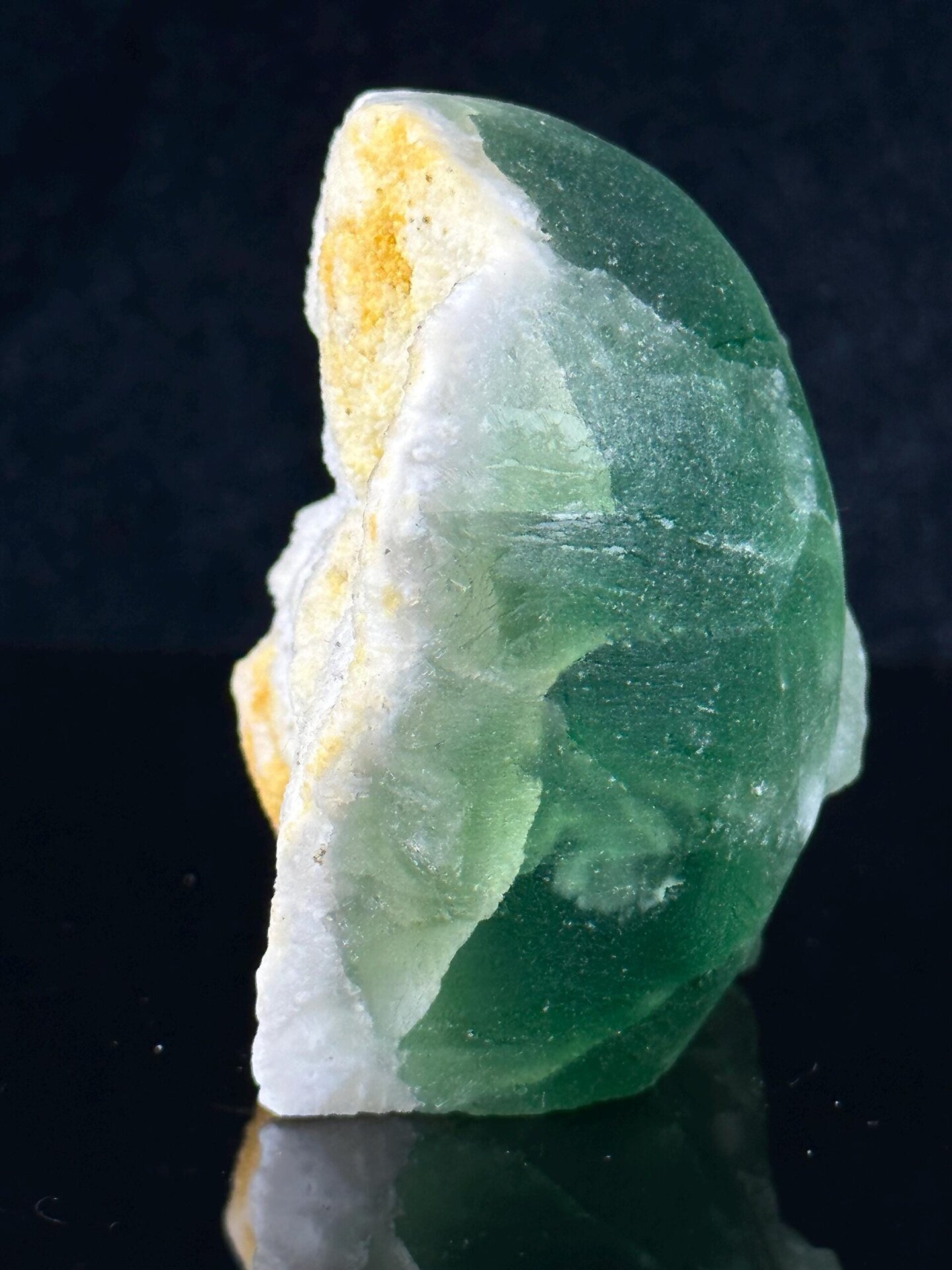 Three-quarter view of green fluorite skull with matrix