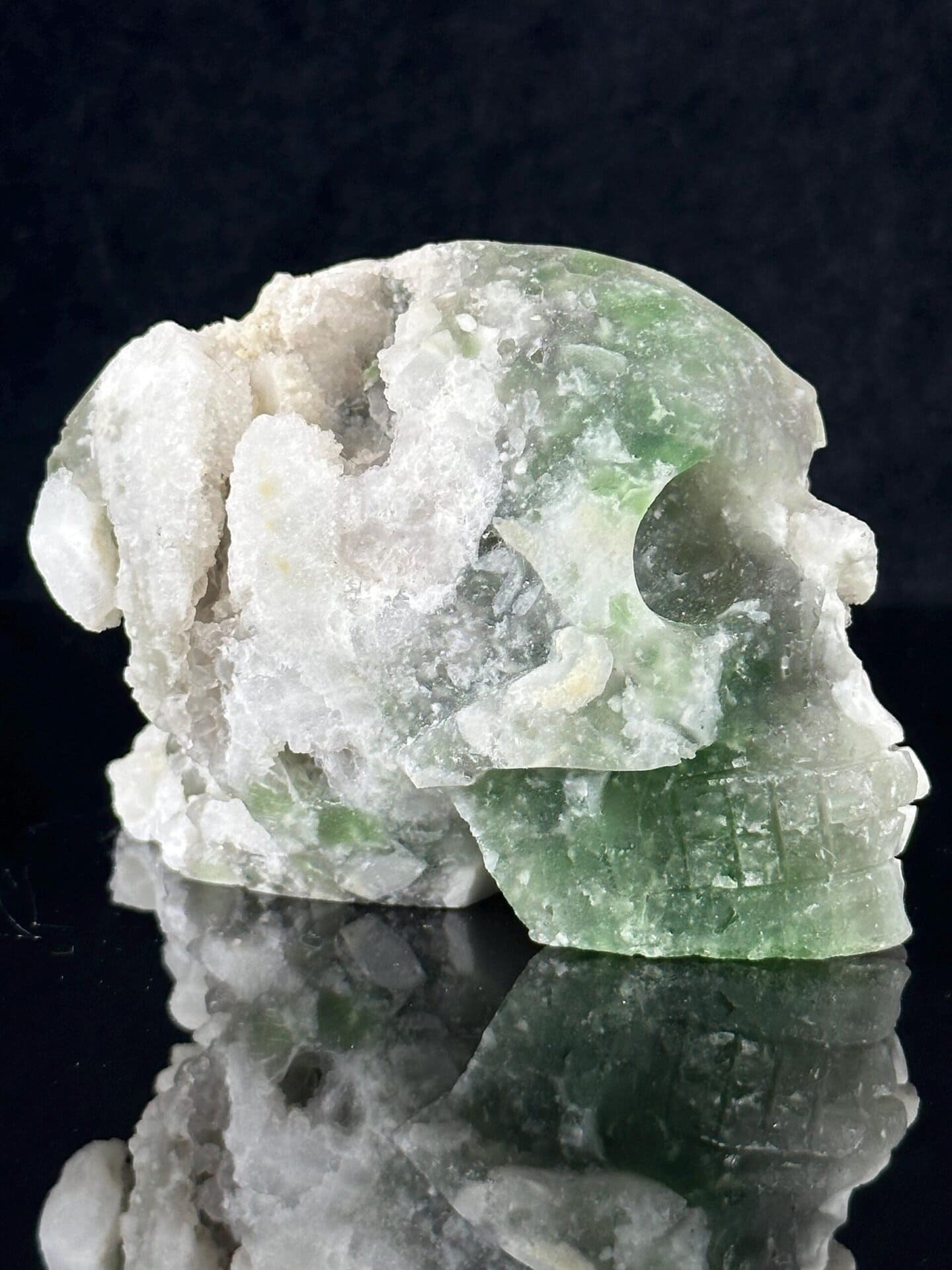 Large hand-carved fluorite skull under studio lighting