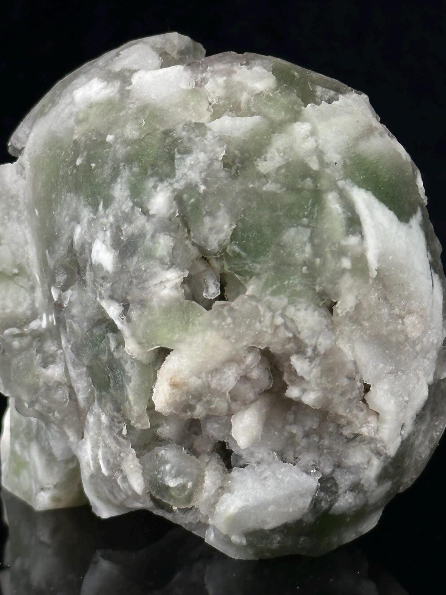 Contrast of carved surface and raw geode on fluorite