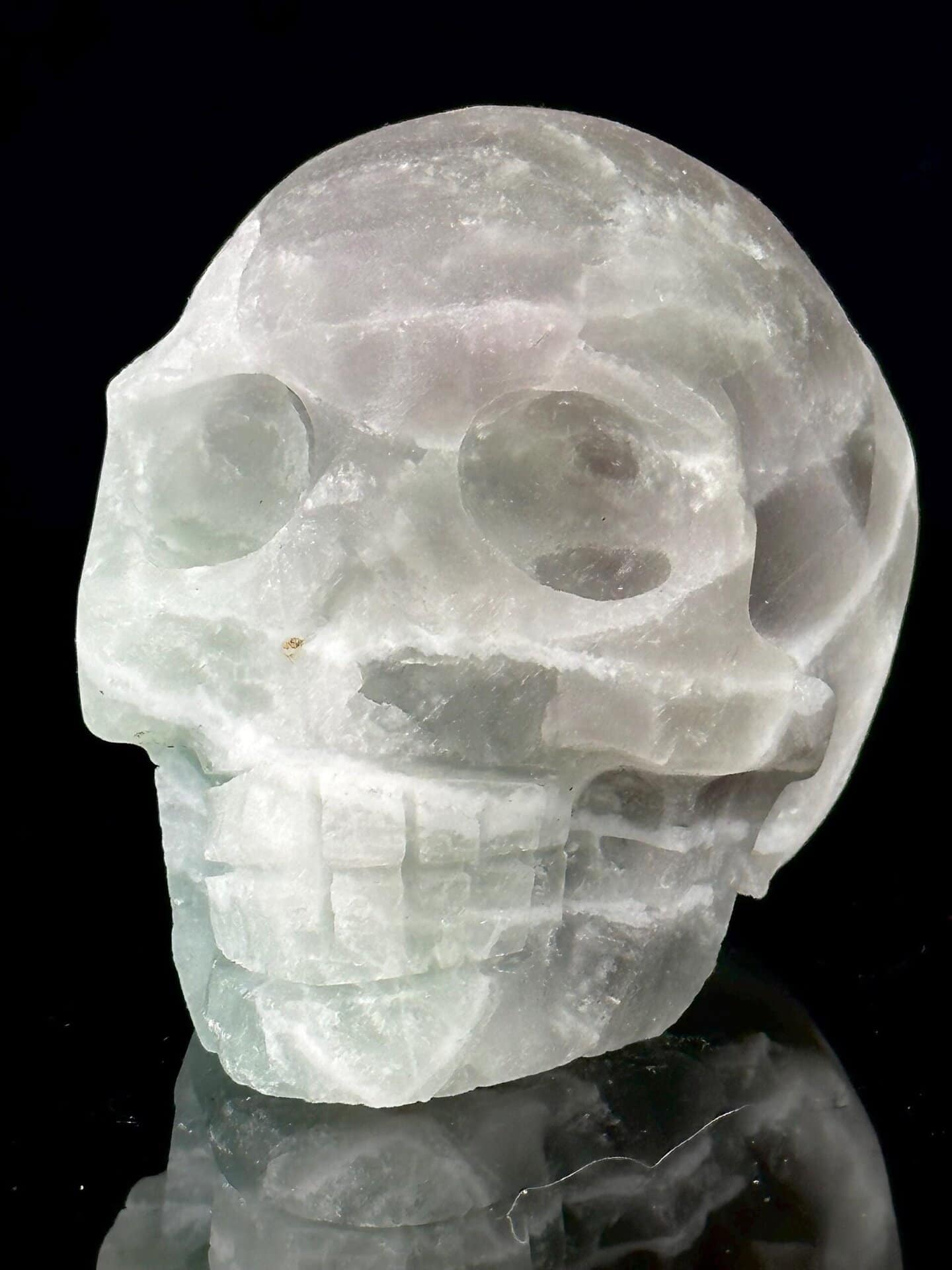 Close-up of carved fluorite face with green mineral banding