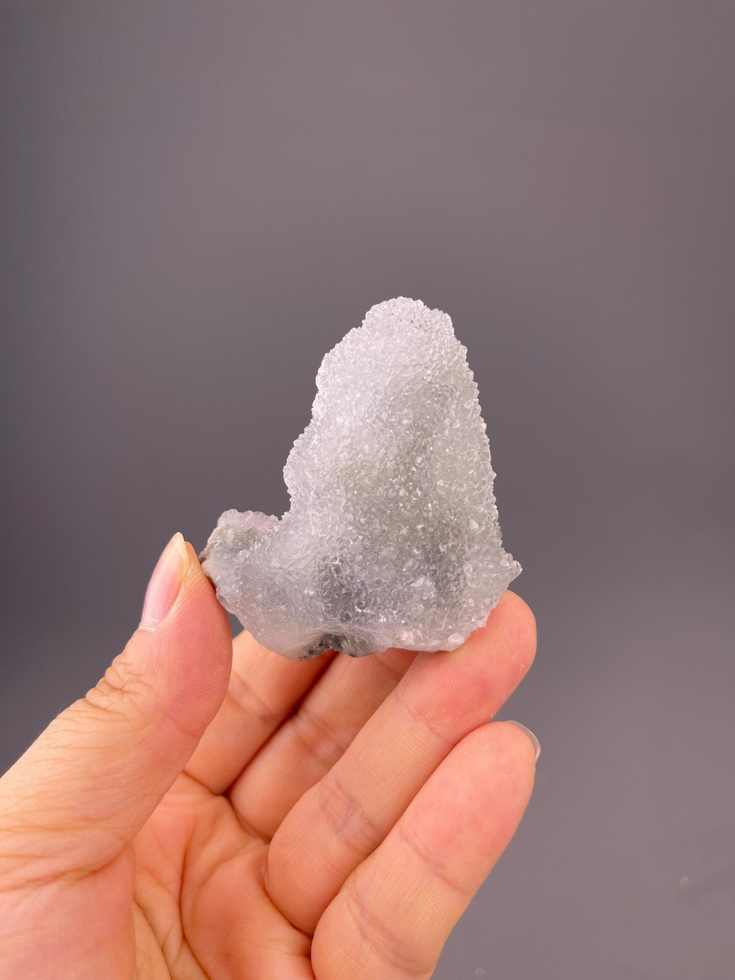 Translucent fluorite visible beneath quartz crust