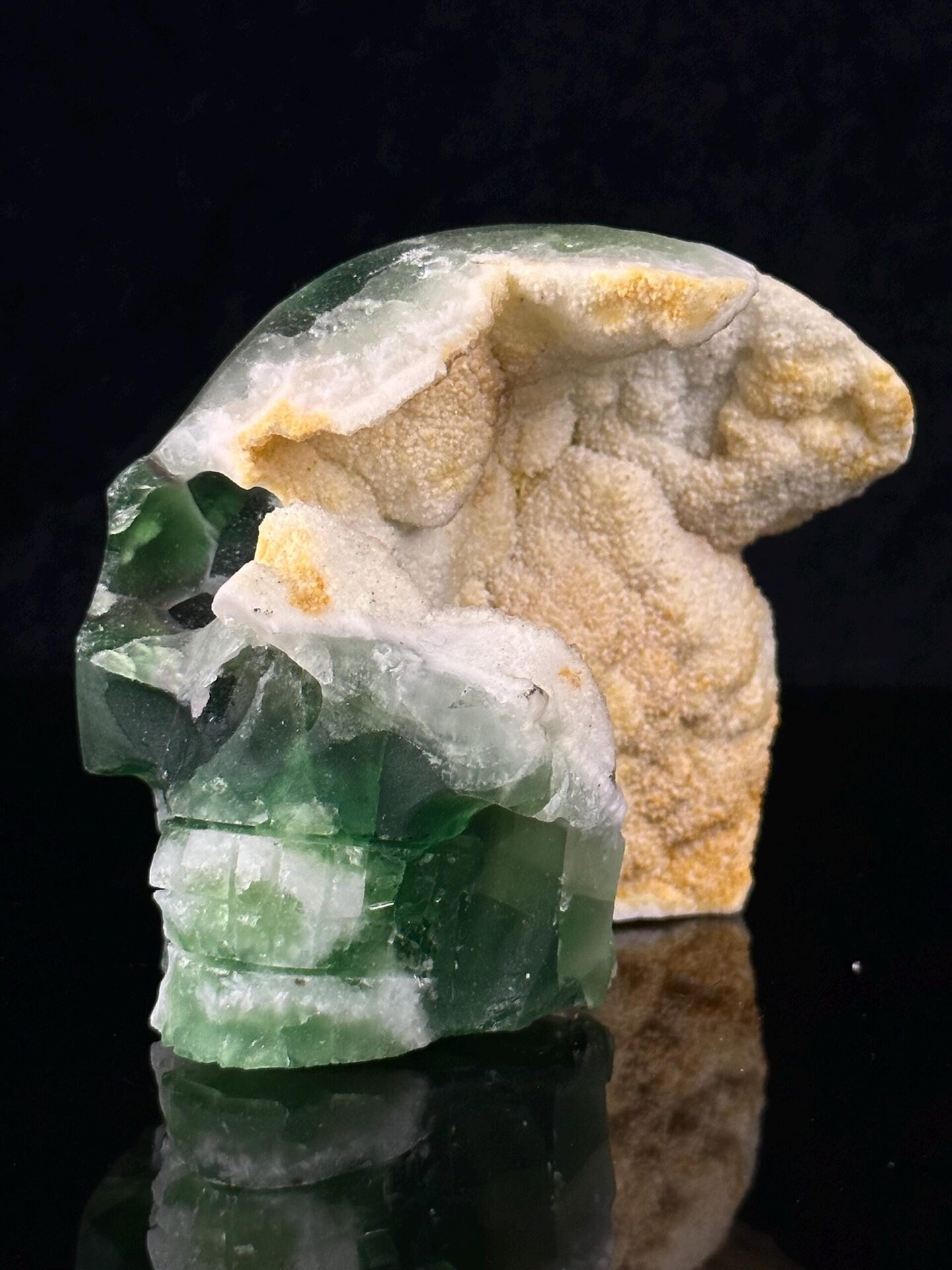 Front view of green fluorite skull showing carving detail
