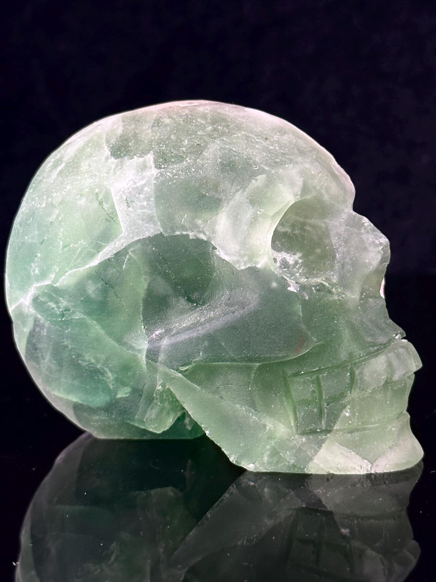 Three-quarter angle of green fluorite skull carving