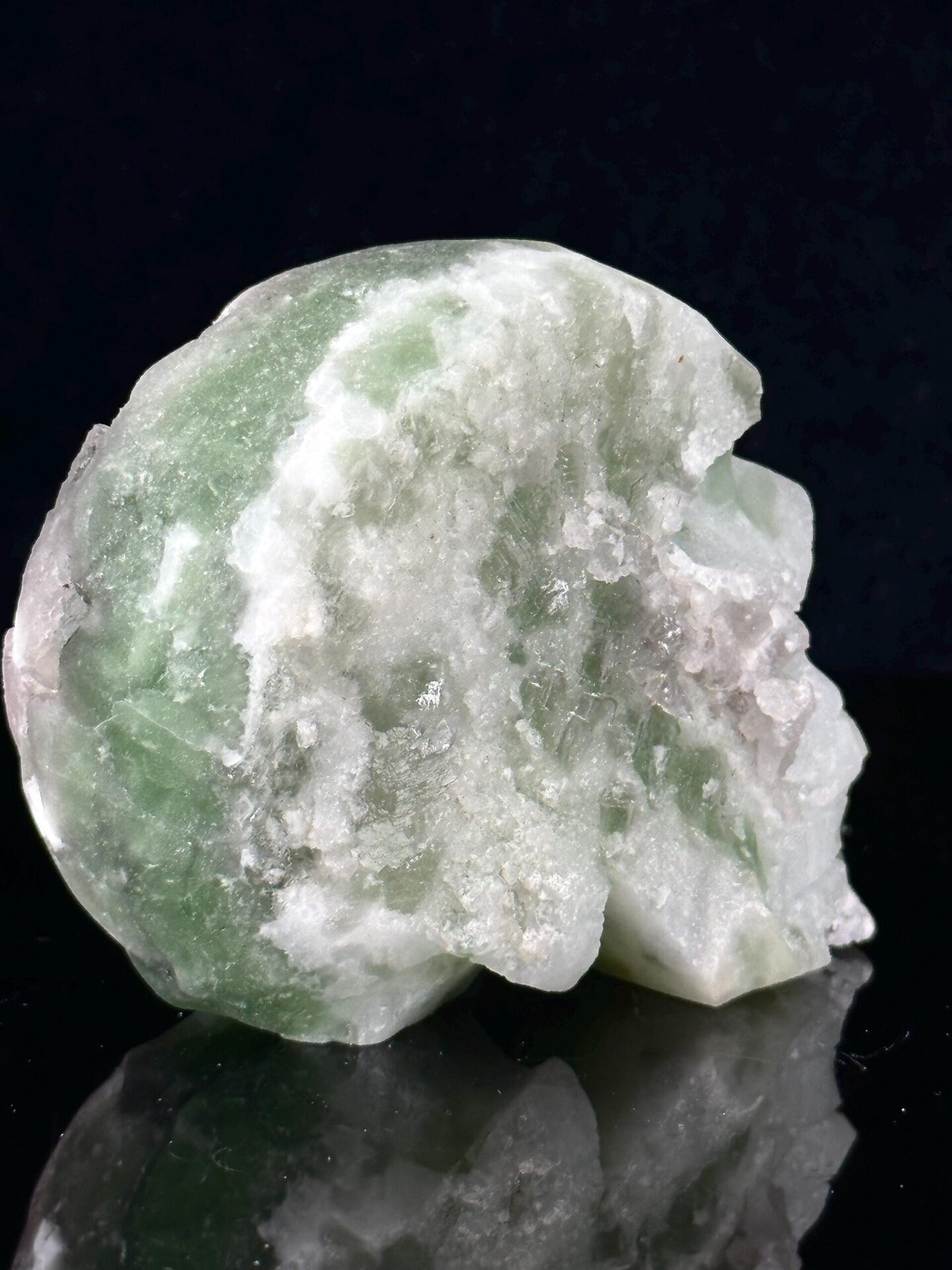 Angled view of green fluorite skull with geode interior