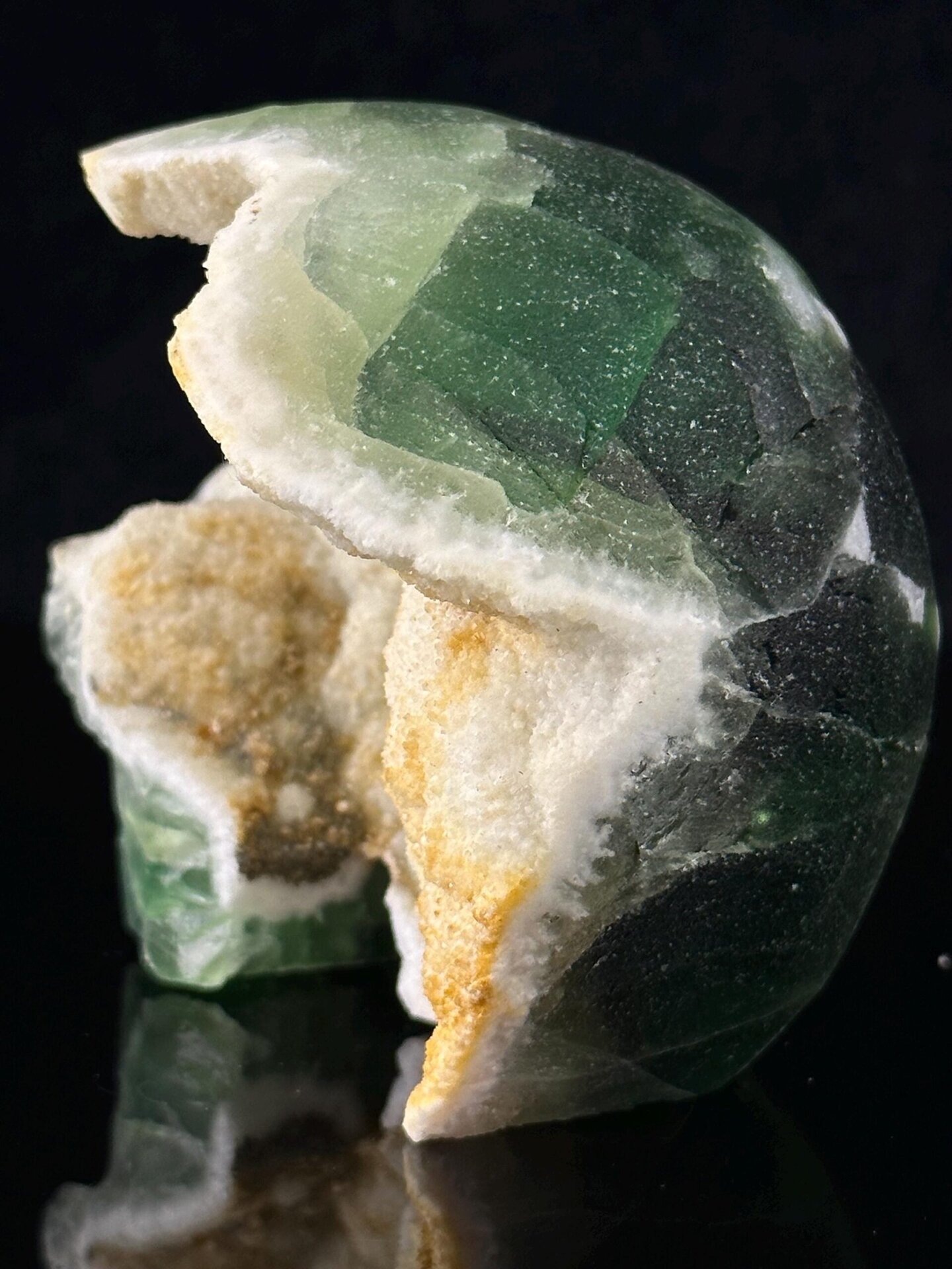 Angled view of green fluorite skull with geode interior