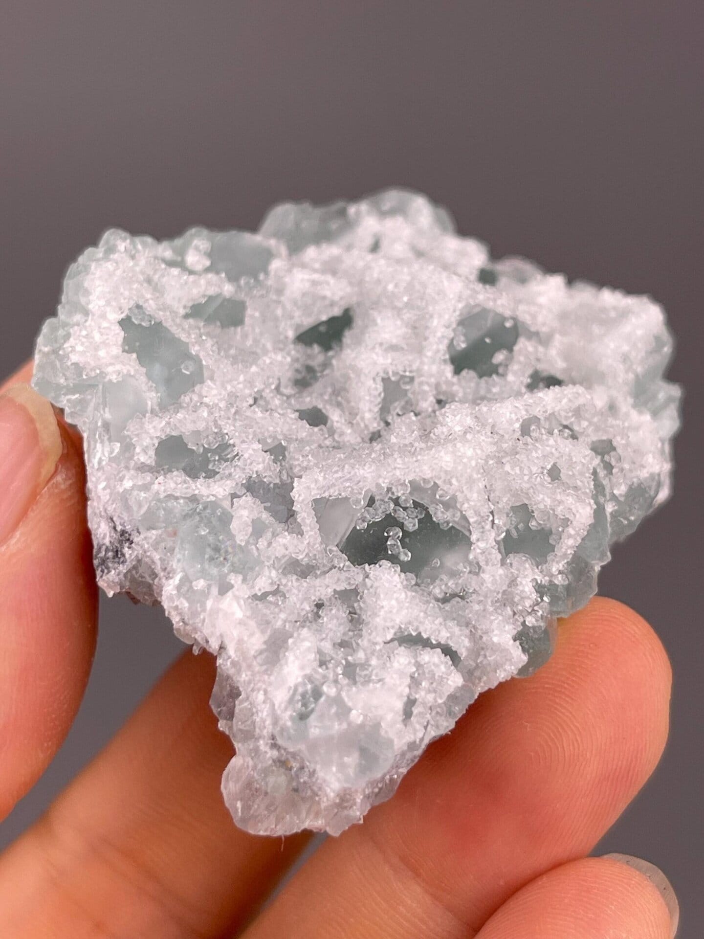 Translucent green fluorite encrusted with fine druzy quartz, China