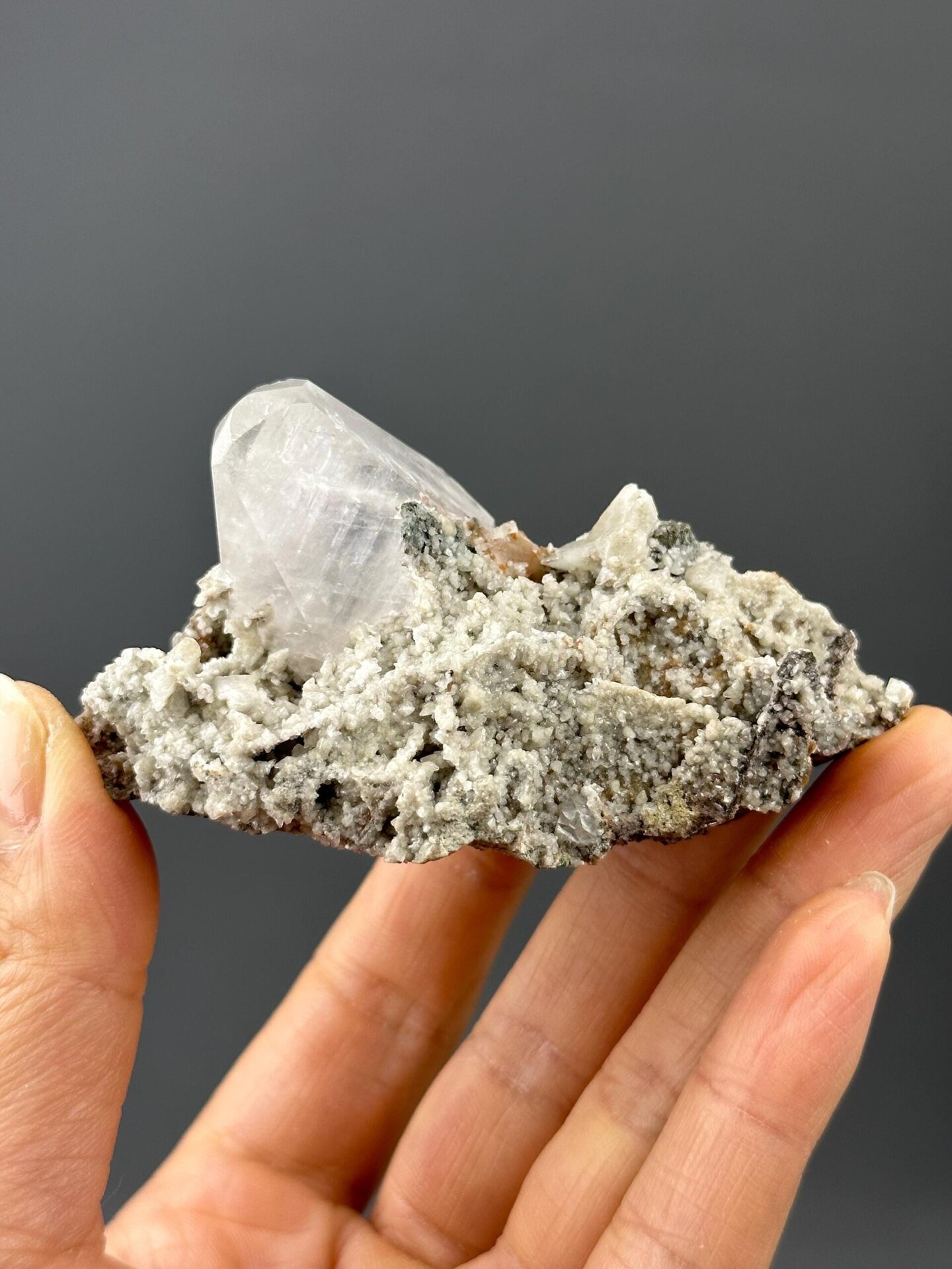 Transparent calcite cluster from Hunan fluorescing orange-red under UV light