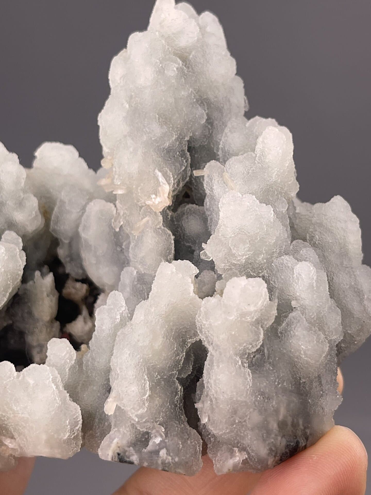 Front view of botryoidal quartz cluster, 37×25×27 mm, light blue coloration