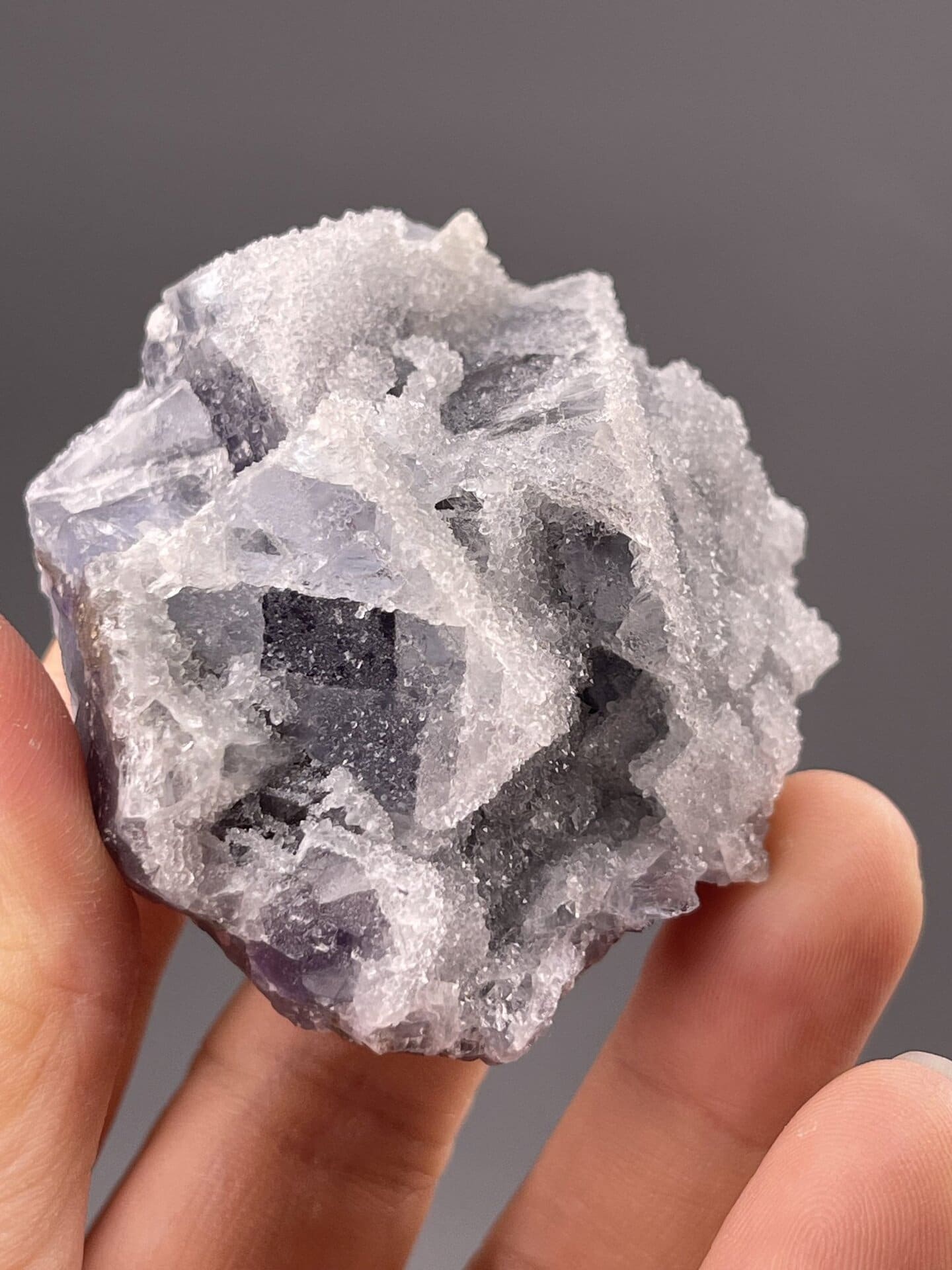 Close-up of purple fluorite cubic faces showing vitreous surfaces