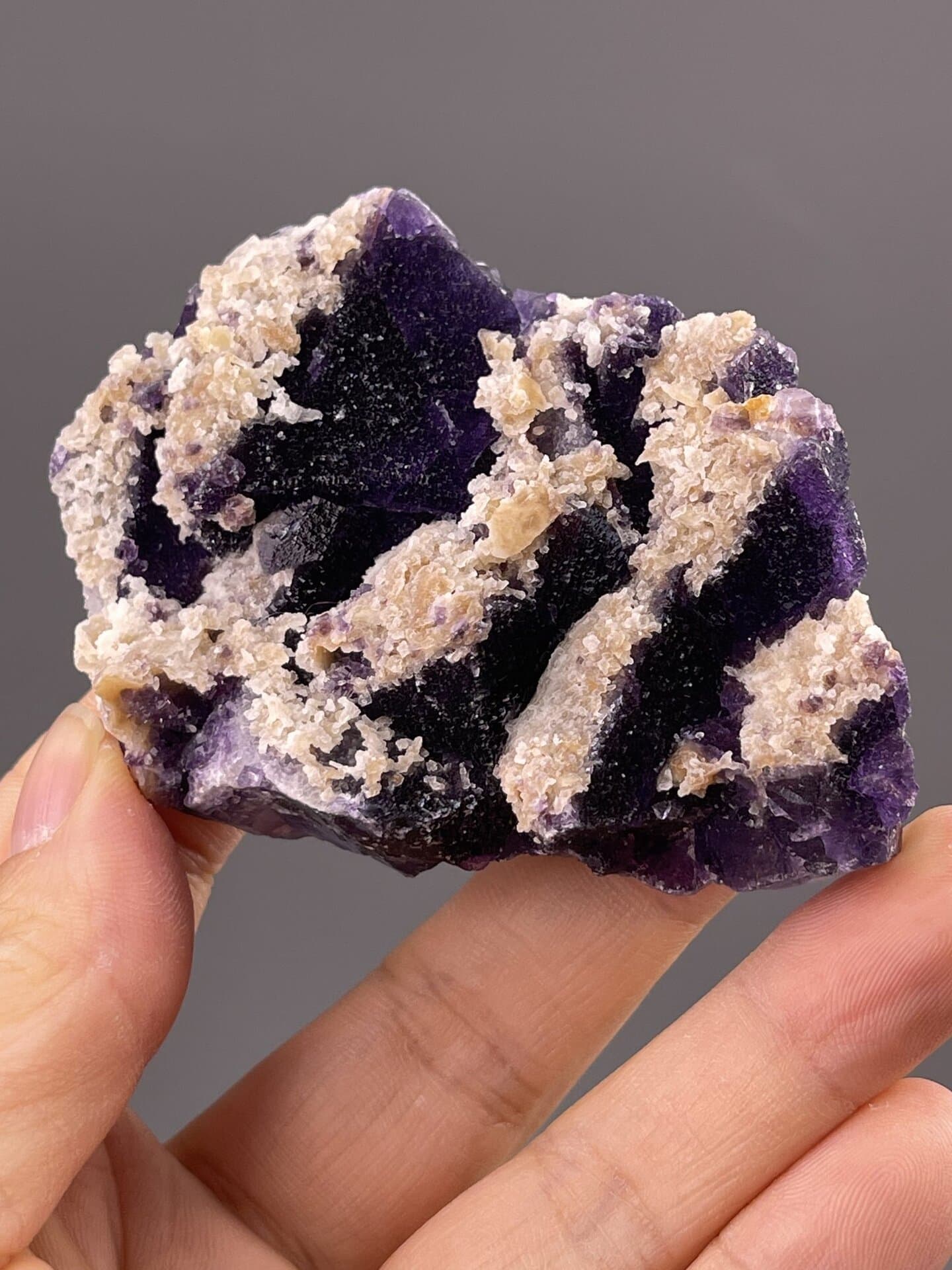 Close-up of purple fluorite surface showing cubic crystal texture