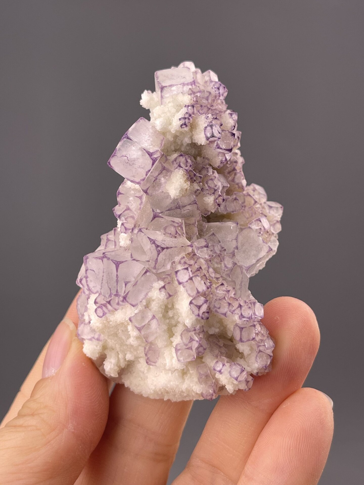 Well-formed purple fluorite cube showing colour variation, 3 g