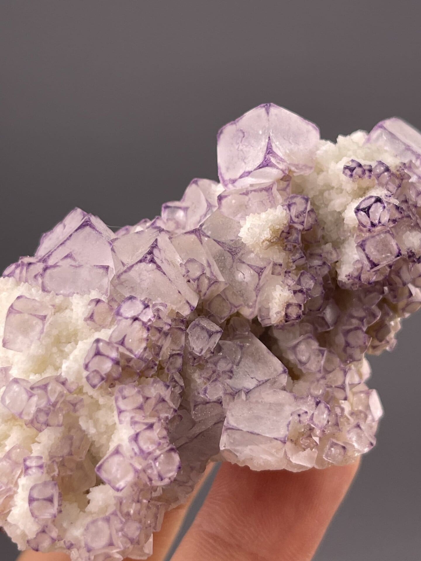 Angled view of Guizhou fluorite cube highlighting colour zoning