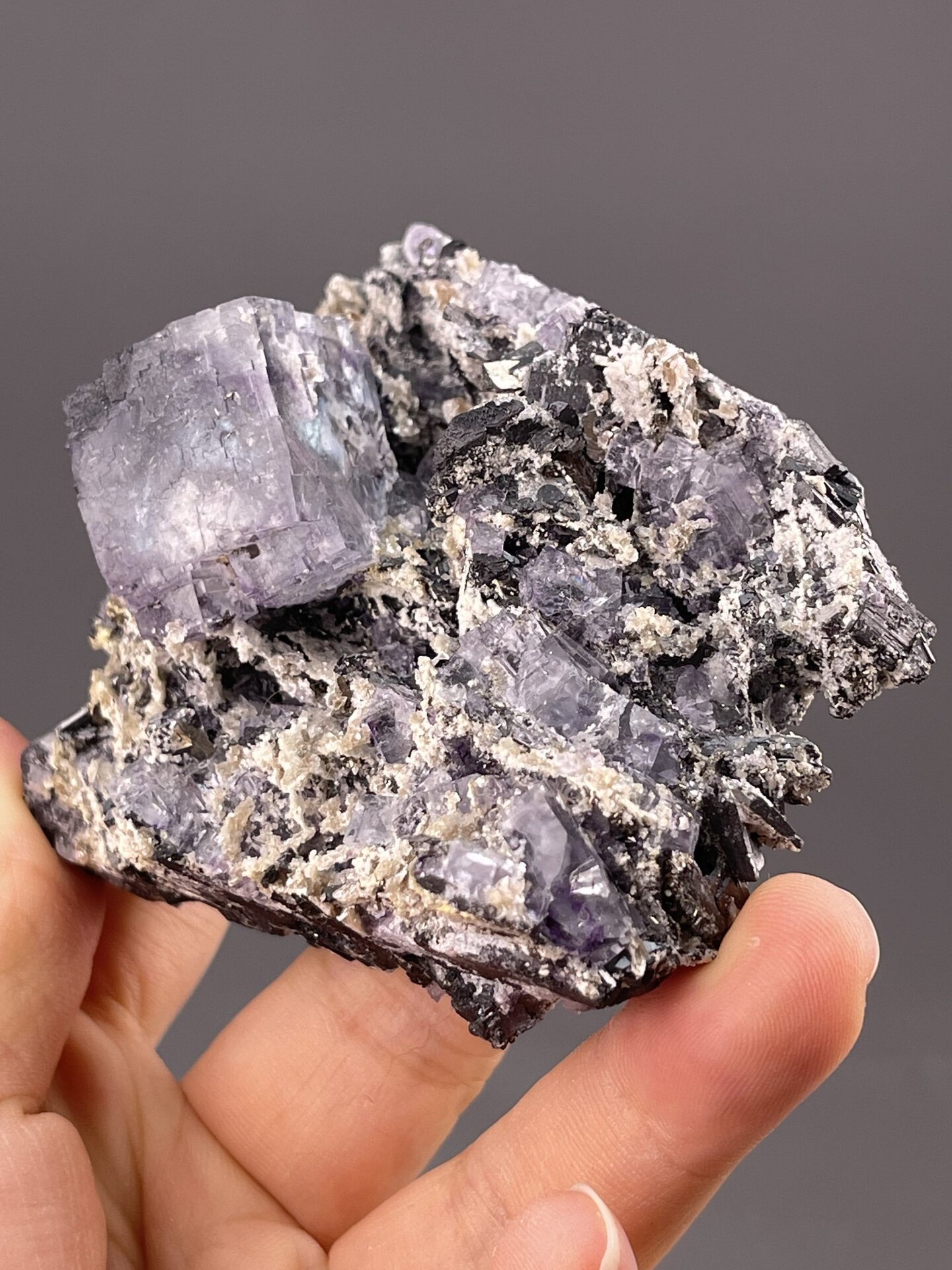 Purple Fluorite Crystals with Phantom Zones from Yaogangxian – angled view showing matrix