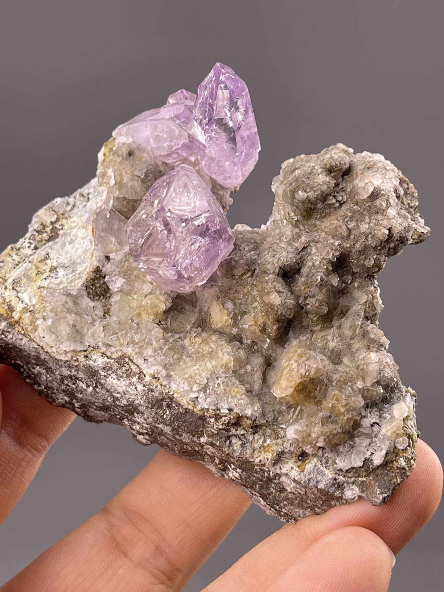 Close-up of amethyst crystal faces showing pale purple coloration