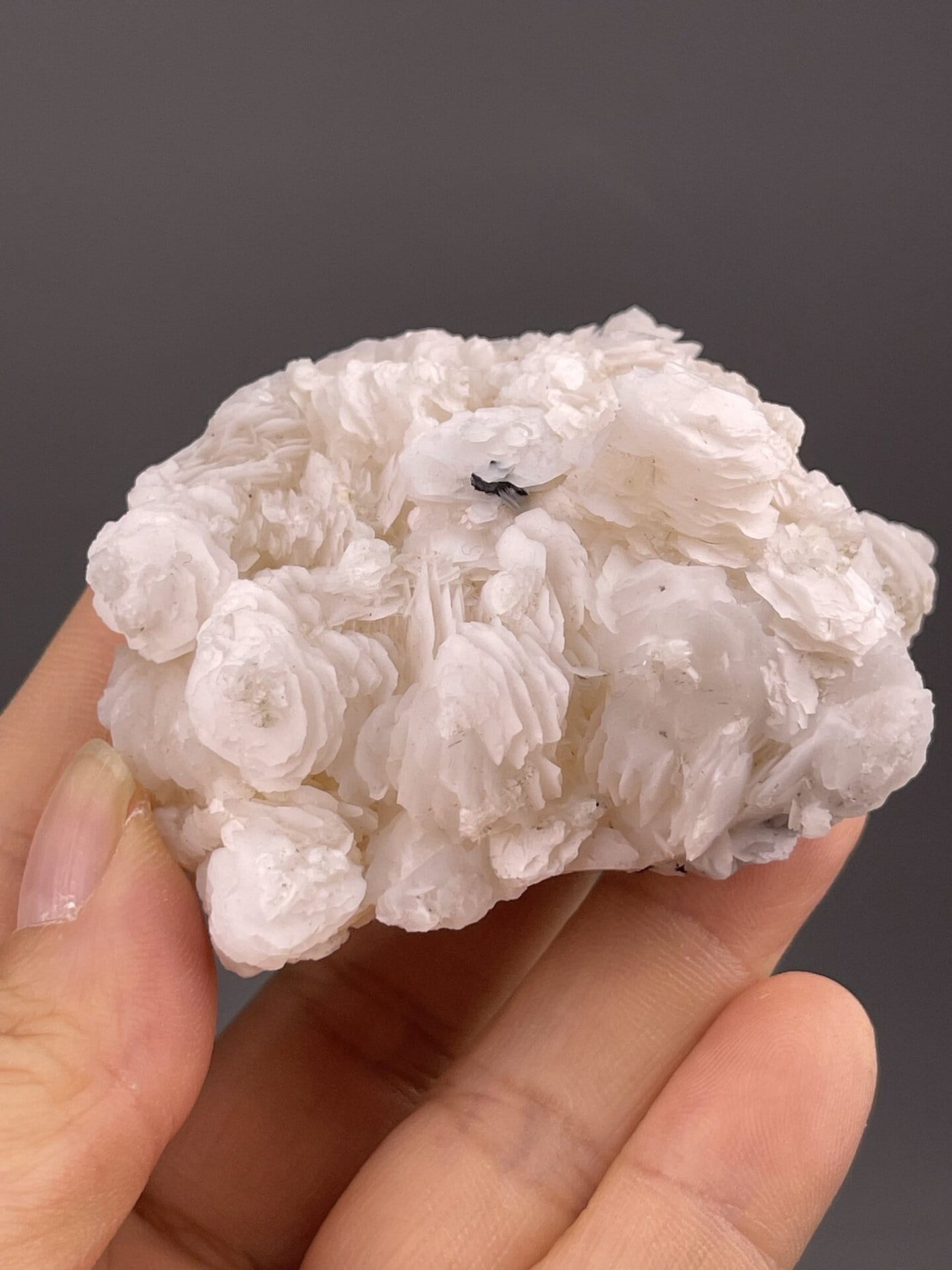 Silky white layered calcite showing fibrous crystal texture, 4.1 g