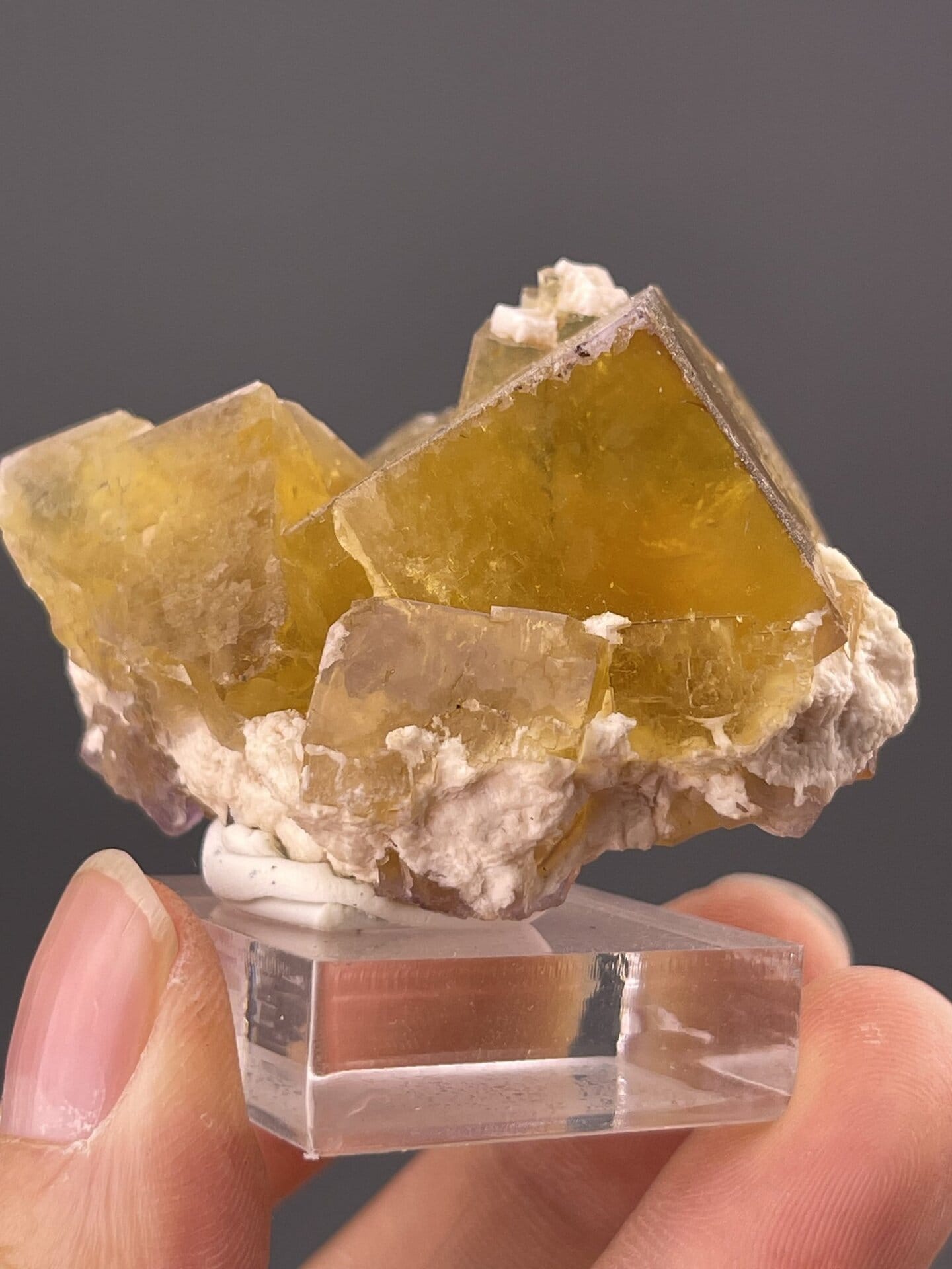 Close-up of fluorite cubic faces showing yellow hue and vitreous sheen
