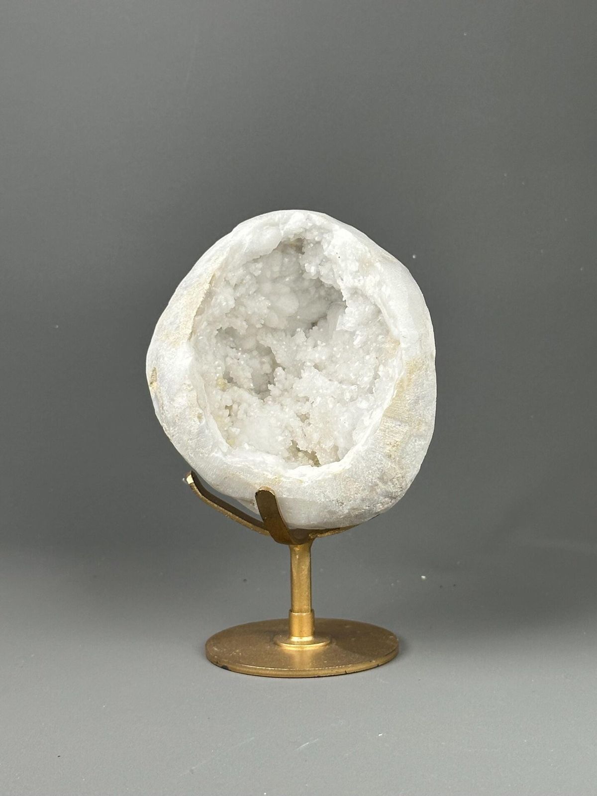 Large quartz geode on decorative gold metal base