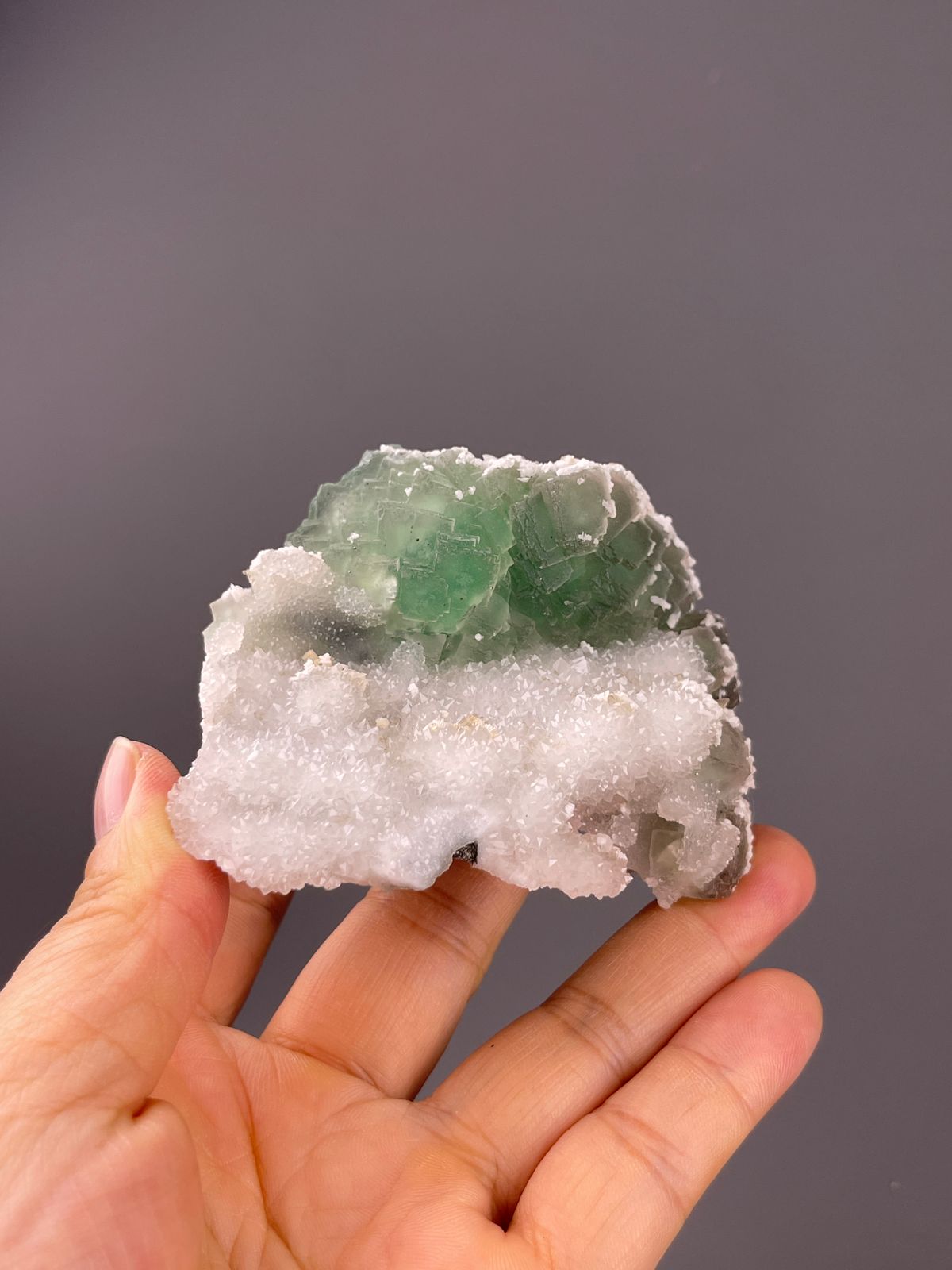 Fluorite from Fujian, China: green stepped crystals above white quartz druse.