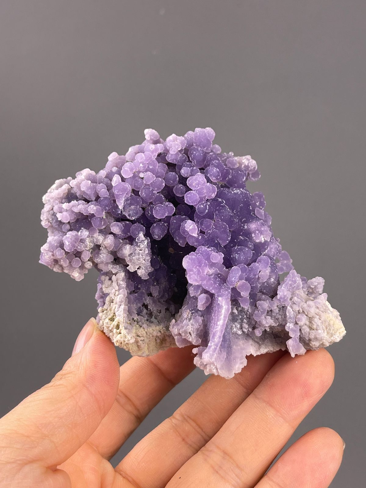 Grape Agate from Indonesia: purple nodules framing a central hollow.