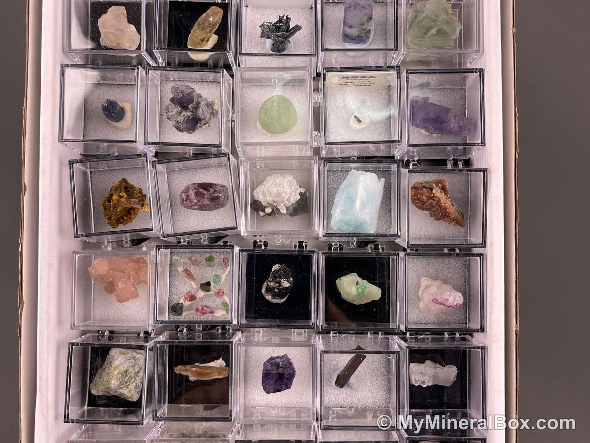 Bulk003 actual mixed mineral specimen box with about 35 different mini natural specimens, including likely fluorite, garnet, stibnite, quartz, aquamarine, tourmaline and grape agate.