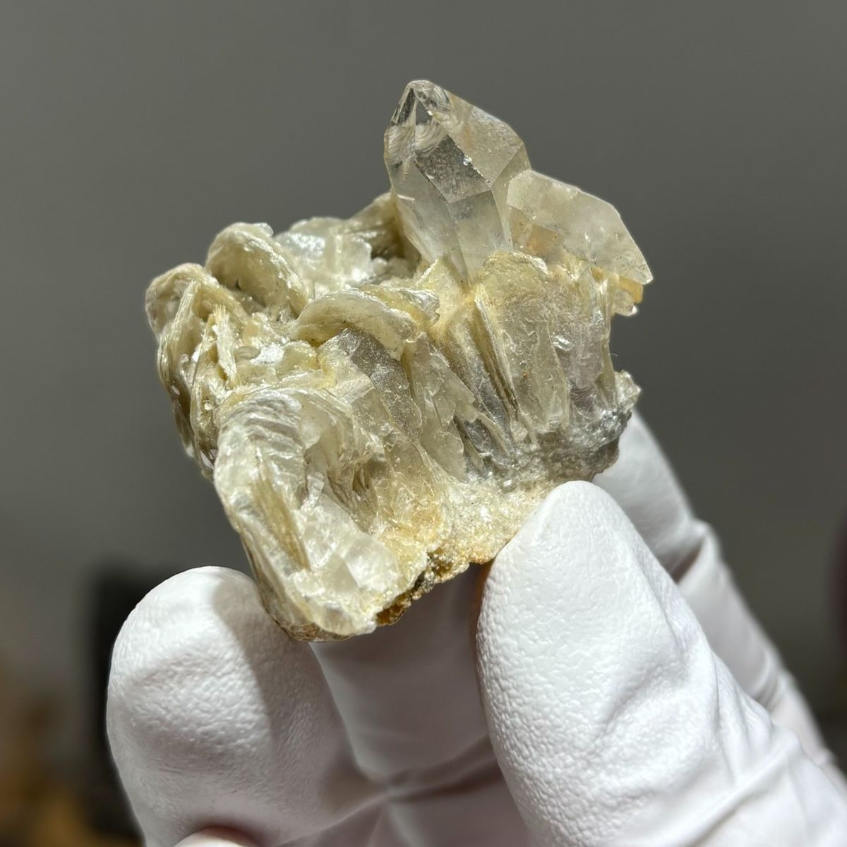 Compact tip-damaged Xuebaoding quartz — complete view