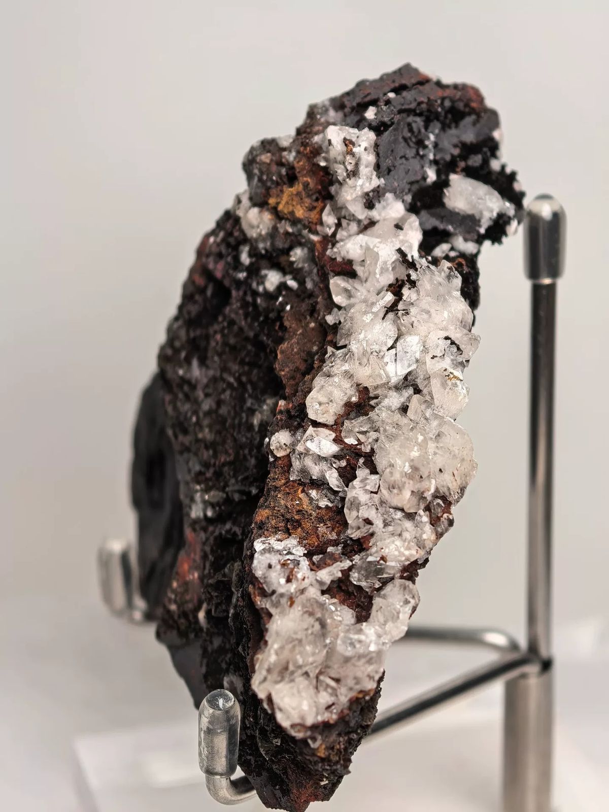 Calcite Crystals on Dark Limonite Ridge — Guizhou — individual mineral specimen view 1