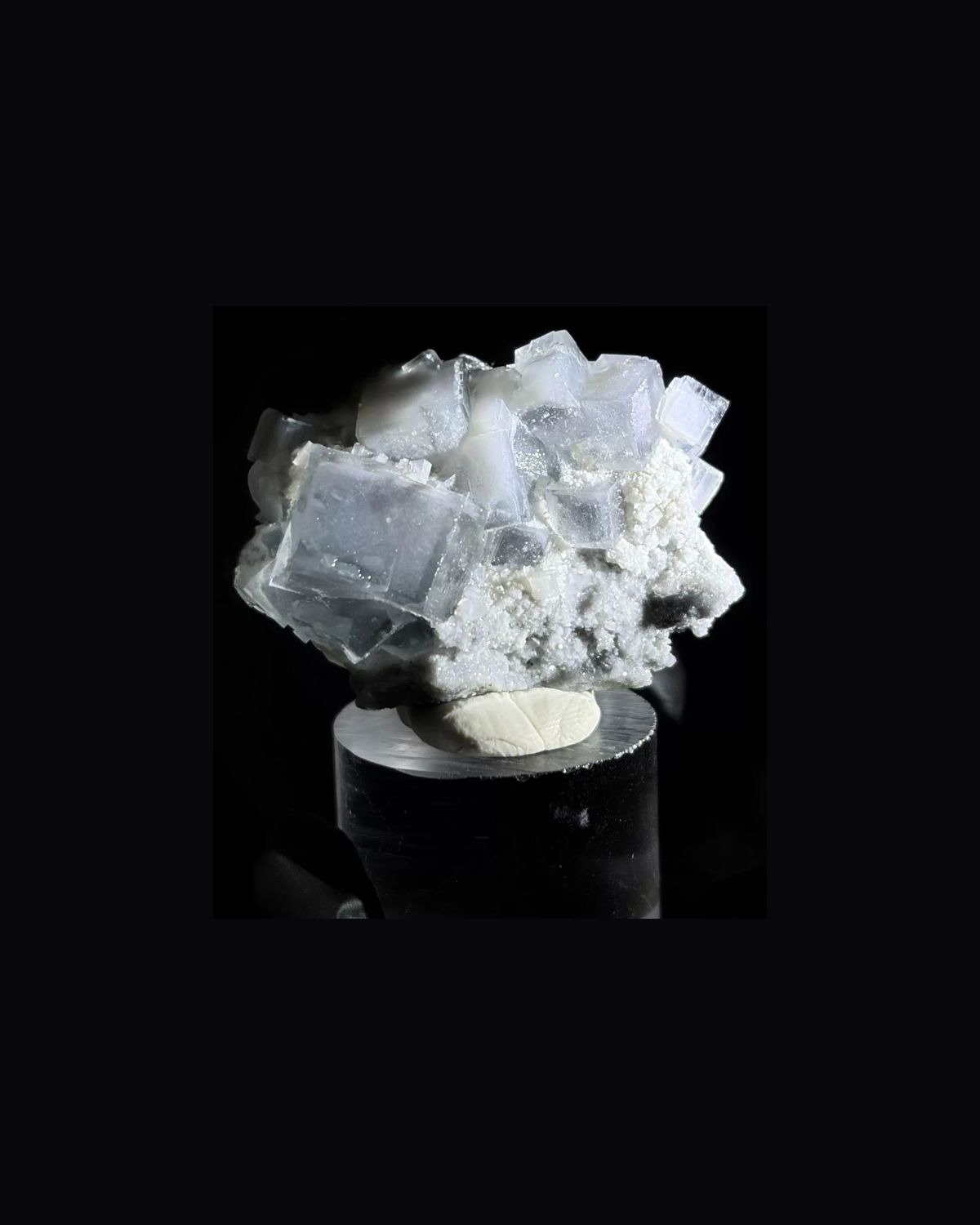 Complete front view of pale gray Xianghualing fluorite with quartz