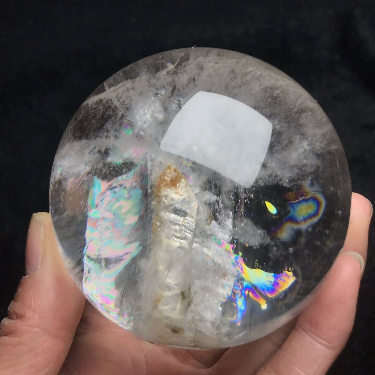 Clear quartz sphere with an enclosed skeletal crystal and rainbows