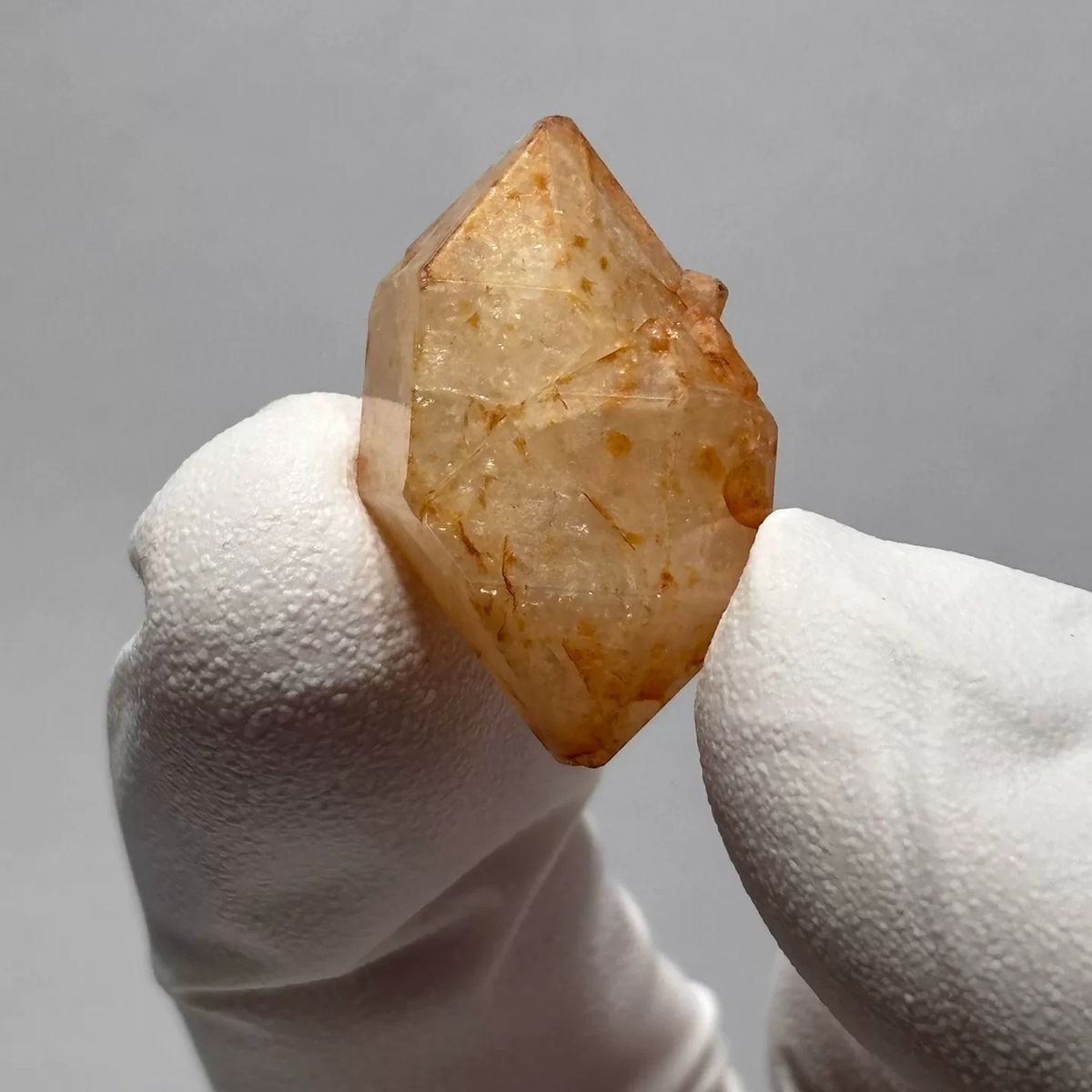 Yunnan quartz crystal with orange iron-oxide inclusions — complete view