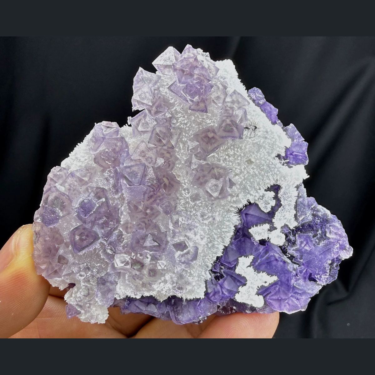 Green-core octahedral purple fluorite on quartz — complete view