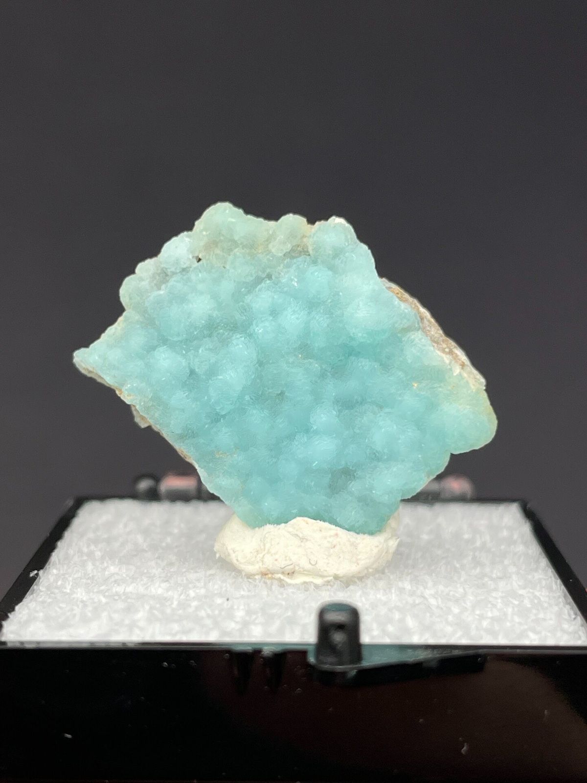 Pale turquoise botryoidal hemimorphite crust from Yunnan, China, in a display box