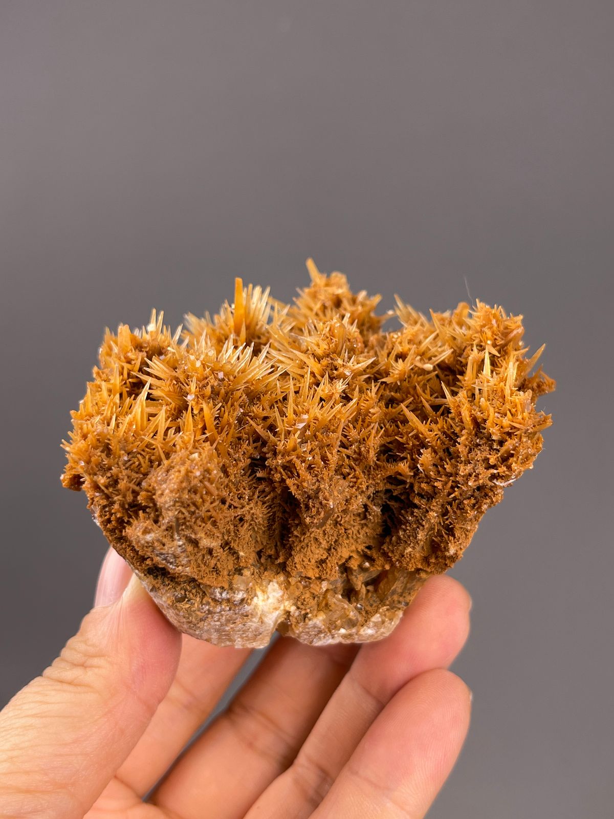 Unidentified specimen from Yunnan, China: orange brown sprays above a pale matrix edge.
