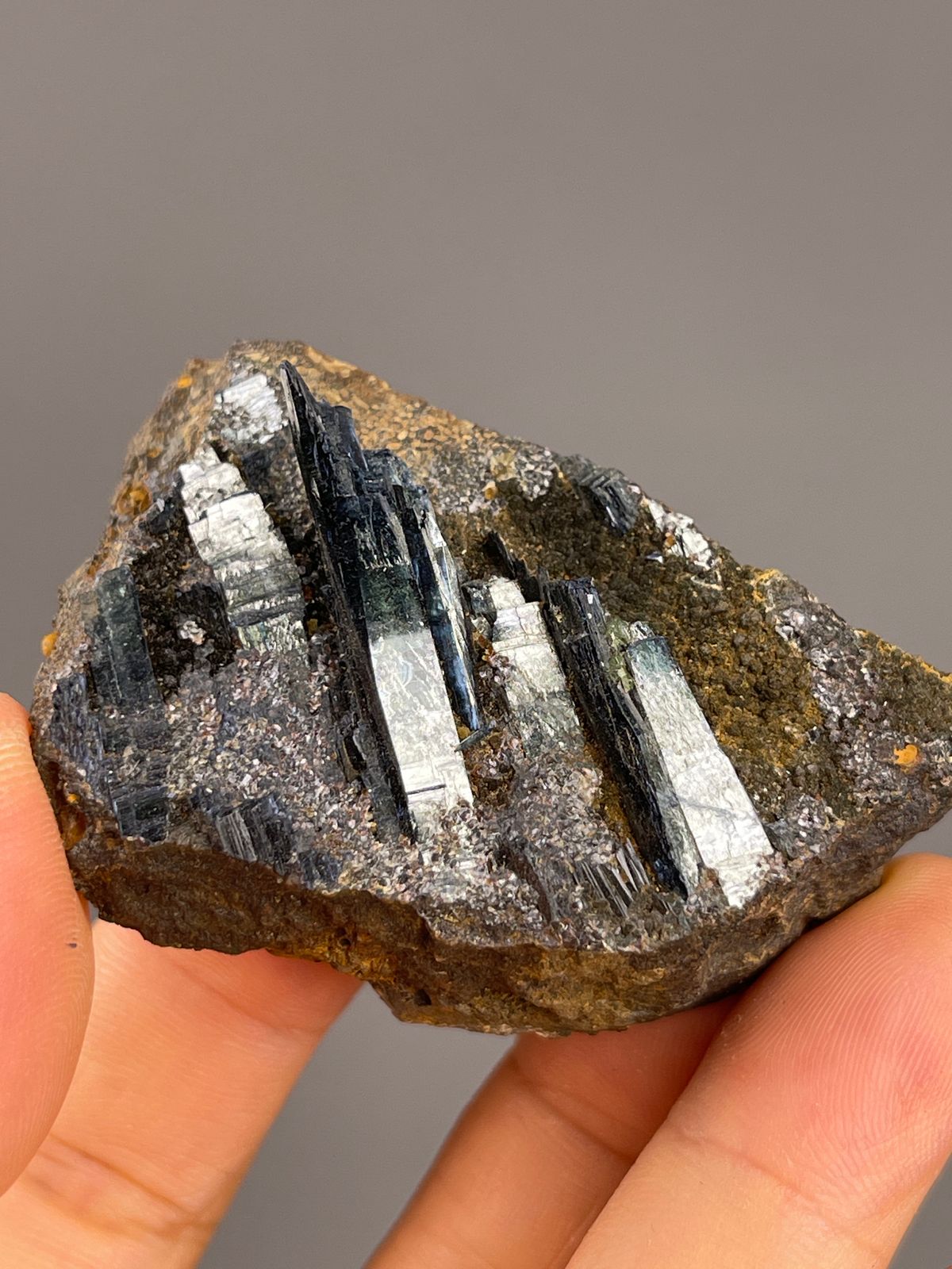 Vivianite from Brazil: scattered dark blades across broad brown matrix.