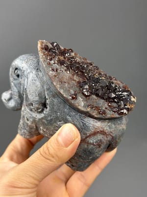 Hand-carved garnet elephant sculpture with onyx eyes