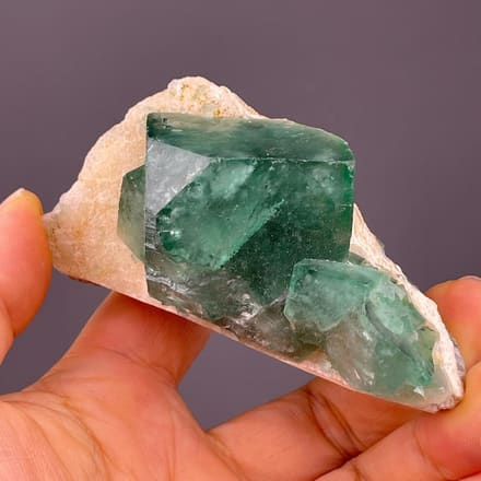 Daylight-reactive green fluorite cube from Madagascar