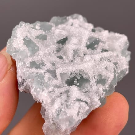 Translucent green fluorite encrusted with fine druzy quartz, China