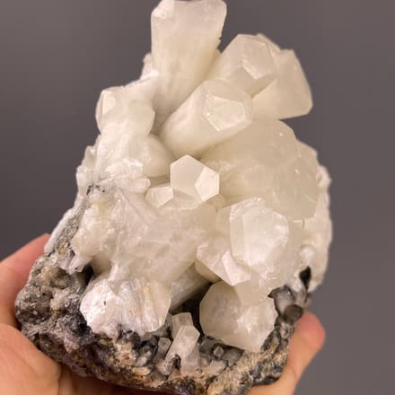 Calcite from Fujian, China: white columns rising from dark matrix.