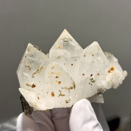Milky Tibetan quartz cluster with imprint marks from Tibet, China, held in gloved hand