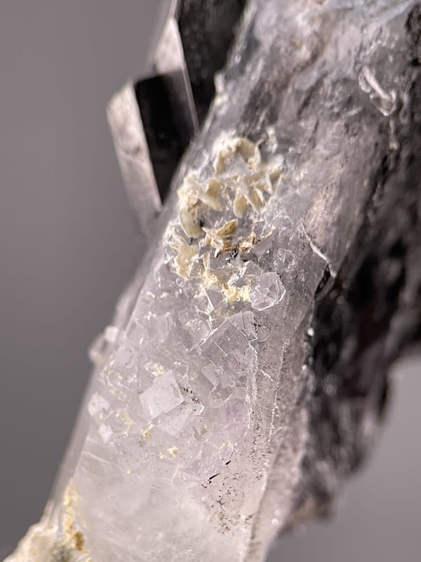 Detail of cassiterite surface showing metallic sheen and striations