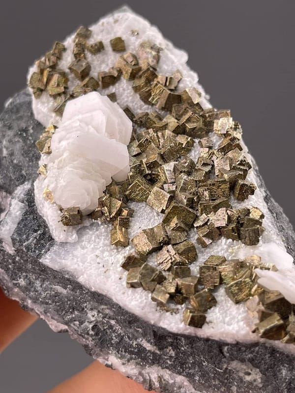 Shimmering pyrite cubes on white calcite, Tonglushan Mine, 2.8 g