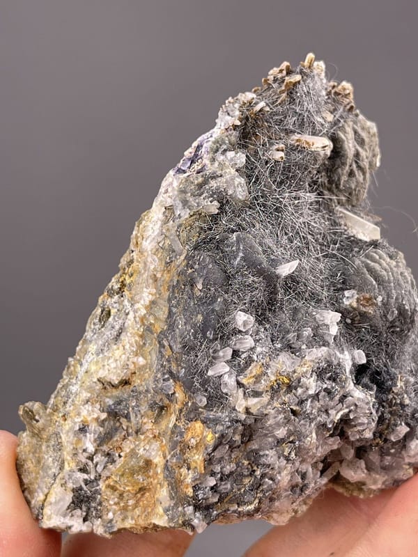 Detail of bismuthinite surface showing brilliant metallic luster