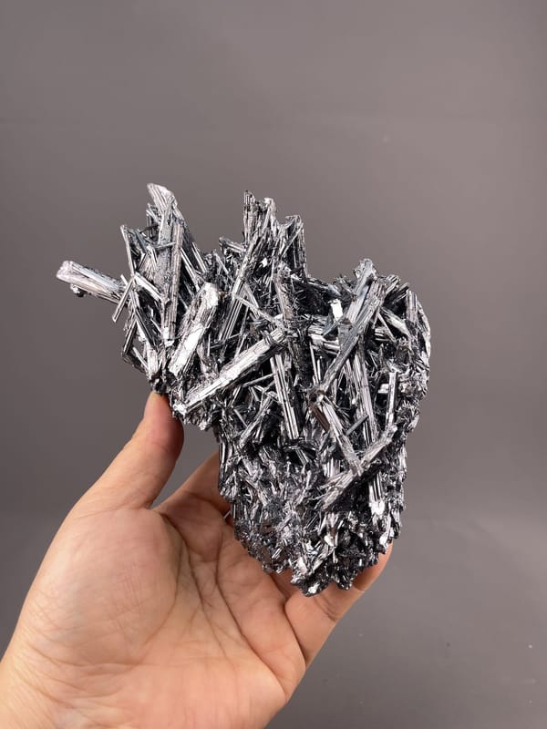 Stibnite Crystal Formation from Hunan, China – angled view showing matrix