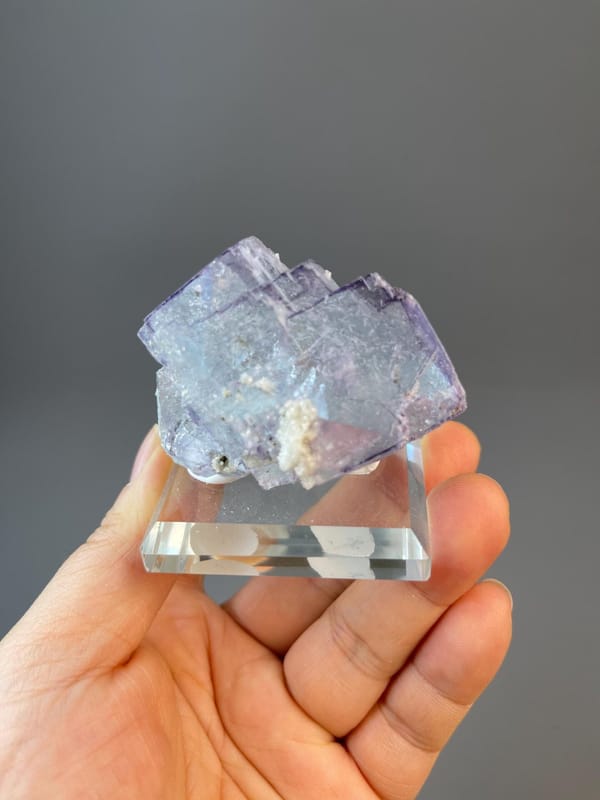 CaF₂ isometric fluorite with stepped cubic faces and needle inclusions