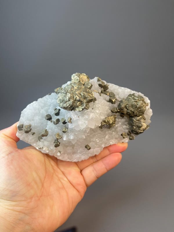 Iridescent chalcopyrite sphere with brassy metallic surface