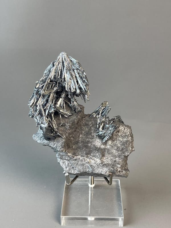 Shimmering metallic luster on stibnite crystals
