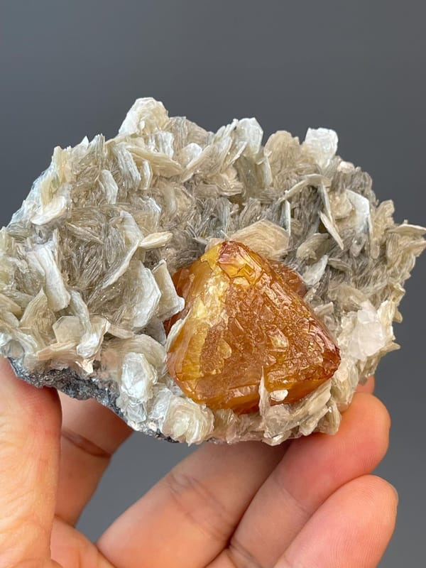 Front view of large orange octahedral scheelite from Xuebaoding
