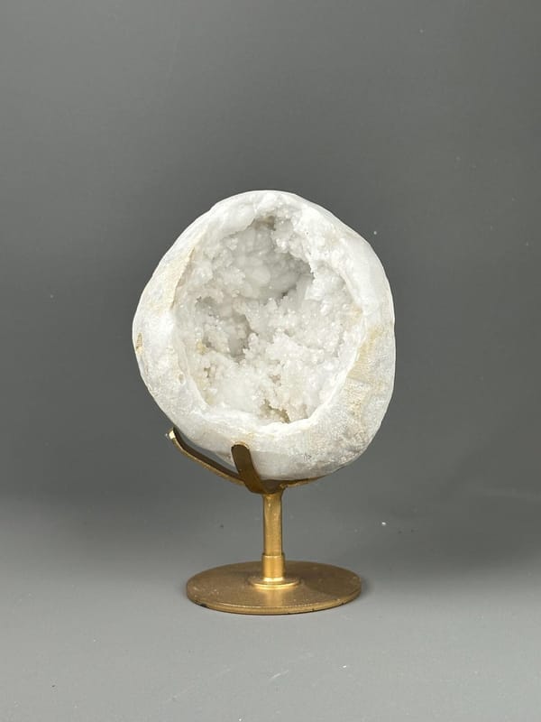 Large quartz geode on decorative gold metal base